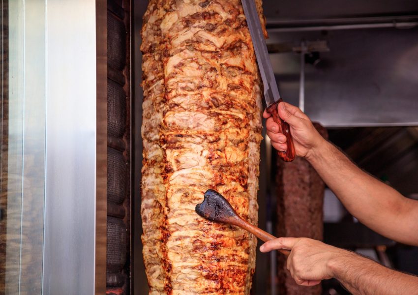 gyros-doner-man-s-hands-holding-a-knife-cutting-2023-11-27-04-51-58-utc