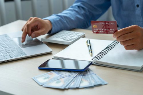 man-holding-credit-card-and-using-smartphone-at-of-2023-11-27-04-53-26-utc