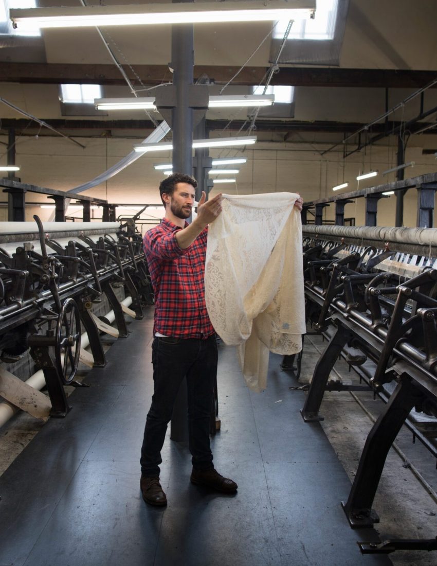 portrait-of-male-weaver-examining-cloth-from-old-w-2023-11-27-05-15-32-utc